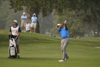 Stewart Cink follows his shot from the 18th fairway of the Silverado Resort North Course during the final round of the Safeway Open PGA golf tournament, Sunday, Sept. 13, 2020, in Napa, Calif. Cink won the tournament after shooting a 7-under-par 65 to finish at total 21-under-par. At left is Cink's caddie and son, Reagan Cink. (AP Photo/Eric Risberg)