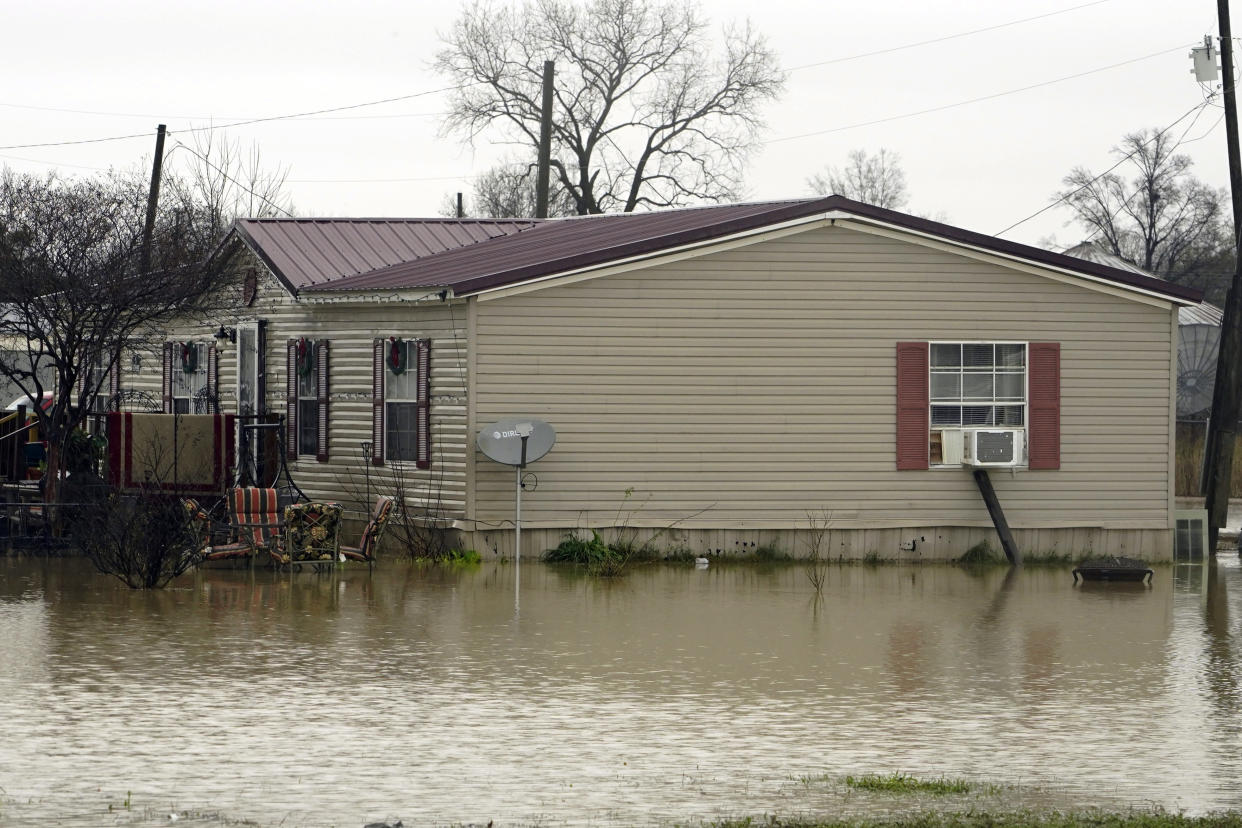 A home in Ruleville, Miss., is flooded from torrential rains that accompanied destructive storms that ripped across the U.S., spawning tornadoes that killed a young boy and his mother in Louisiana, smashed mobile homes and chicken houses in Mississippi and threatened neighboring Southern states with additional severe weather Wednesday, Dec. 14, 2022. (AP Photo/Rogelio V. Solis)