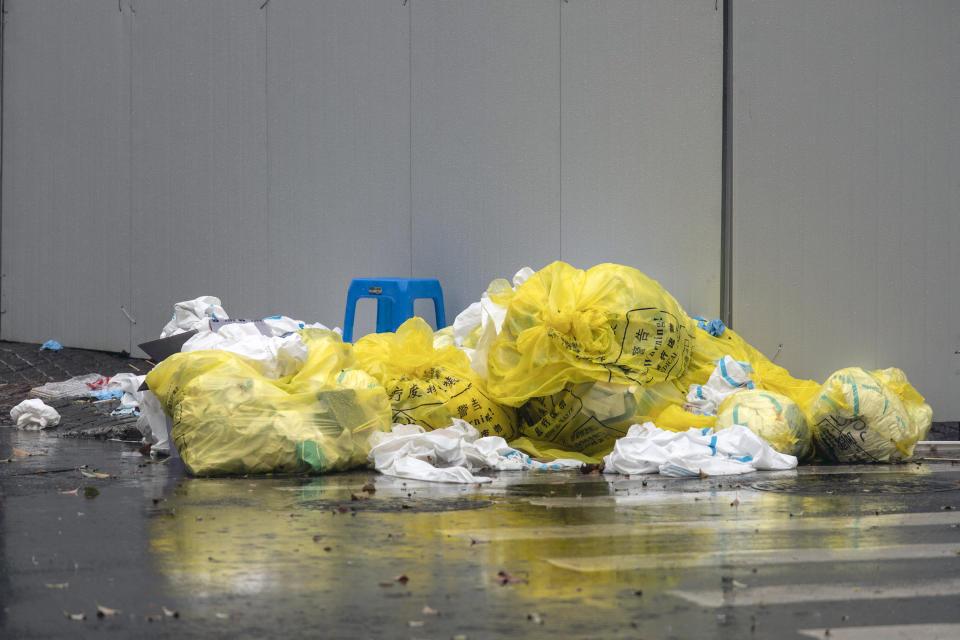 Discarded personal protective equipment (PPE) and rubbish outside a neighbourhood placed under lockdown due to Covid-19 in Shanghai in March. Source: Getty