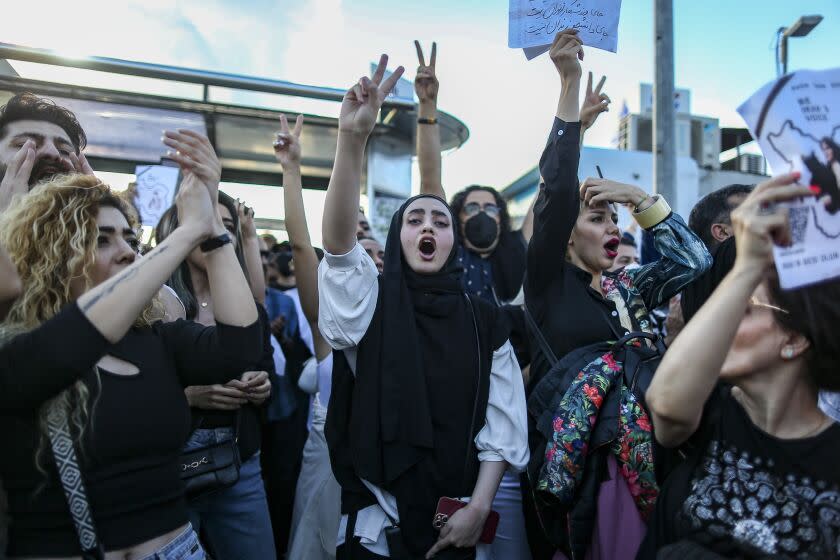 People shout slogans during a protest against the death of Iranian Mahsa Amini, in Istanbul, Turkey, Sunday, Oct. 2, 2022. Thousands of Iranians have taken to the streets over the last two weeks to protest the death of Mahsa Amini, a 22-year-old woman who had been detained by Iran's morality police in the capital of Tehran for allegedly not adhering to Iran's strict Islamic dress code. (AP Photo/Emrah Gurel)