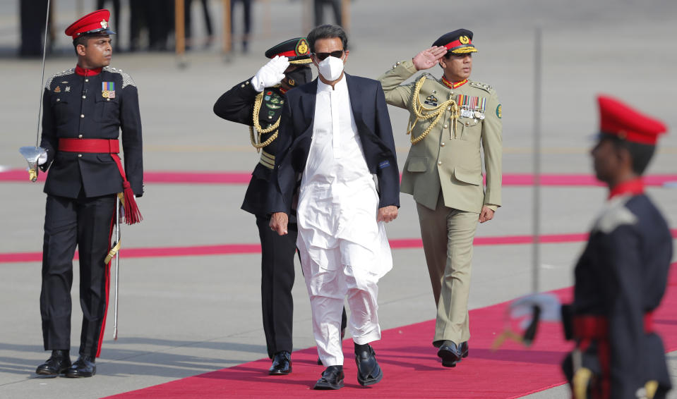 Pakistan's Prime Minister Imran Khan inspects a Guard of Honor upon his arrival in Colombo, Sri Lanka, Tuesday, Feb. 23, 2021. Khan is in Sri Lanka for a two day official visit. (AP Photo/Eranga Jayawardena)