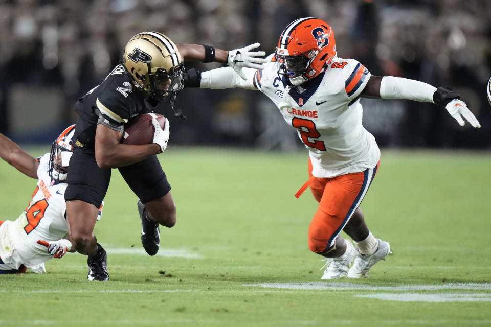 Purdue wide receiver Abdur-Rahmaan Yaseen, left, fends off Syracuse linebacker Marlowe Wax during the second half of an NCAA college football game in West Lafayette, Ind., Saturday, Sept. 16, 2023. (AP Photo/AJ Mast)