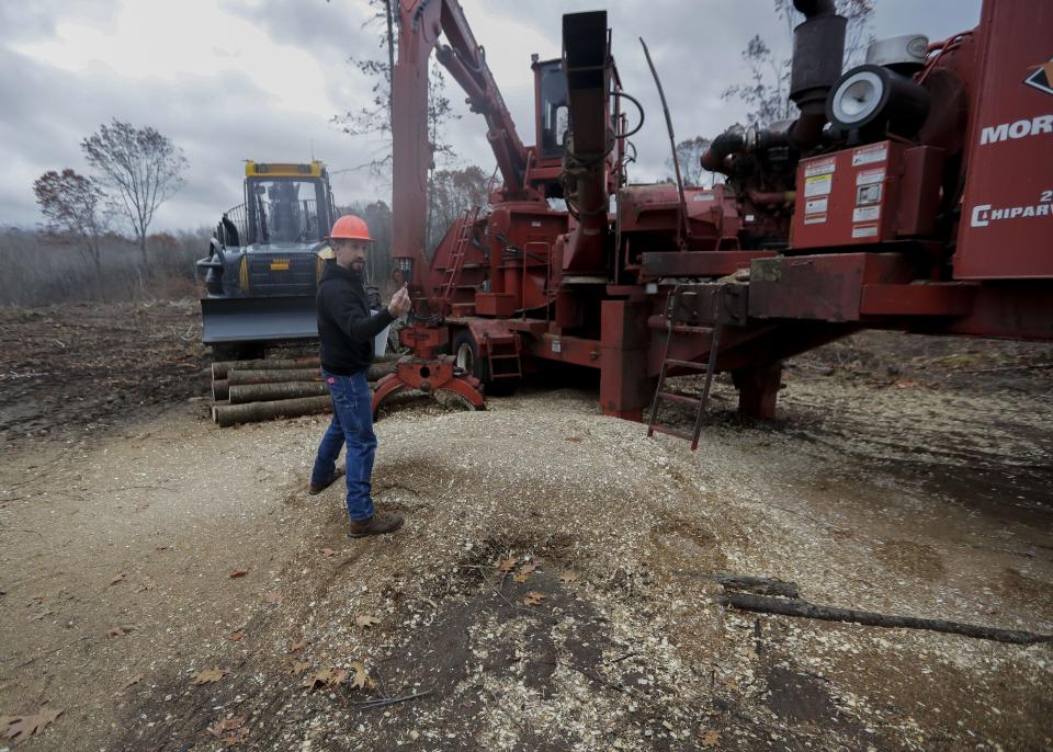 Forester Matt Carothers showcases a log chipper on Monday, October 24, 2022, near Minocqua, Wis.