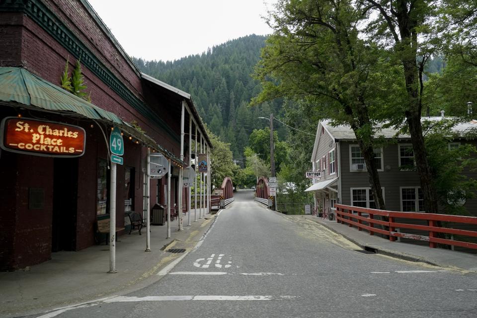 Trees are visible from the town of Downieville, Calif., Tuesday, June 6, 2023. By logging and burning trees and low-lying vegetation, officials hope to lessen forest fuels and keep fires that originate on federal lands from exploding through nearby cities and towns. (AP Photo/Godofredo A. Vásquez)