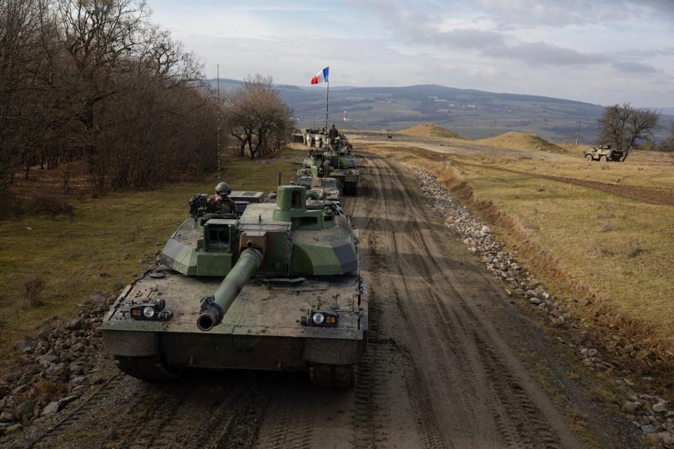 This photograph taken on December 8, 2022 shows French Leclerc tanks of the 1er Regiment de Chasseurs of Thierville-sur-Meuse members of the Battle group forward presence (BG FP) moving at the Cincu military training area, during an exercise with armoured vehicles and infantry, as part of the Aigle Nato Mission in Romania. (Photo by Thomas SAMSON / AFP) (Photo by THOMAS SAMSON/AFP via Getty Images)