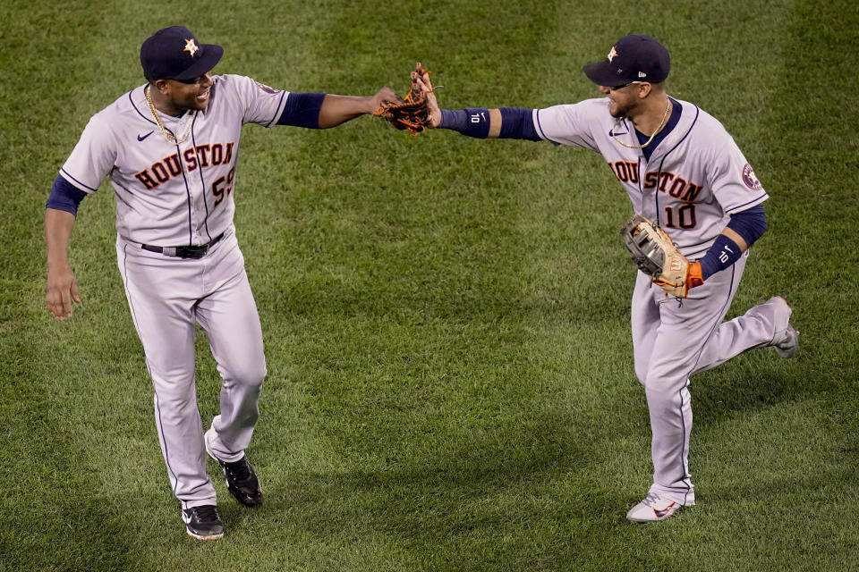 Houston Astros starting pitcher Framber Valdez celebrates the end of the seventh inning with first baseman Yuli Gurriel against the Boston Red Sox in Game 5 of baseball's American League Championship Series Wednesday, Oct. 20, 2021, in Boston. (AP Photo/Charles Krupa)