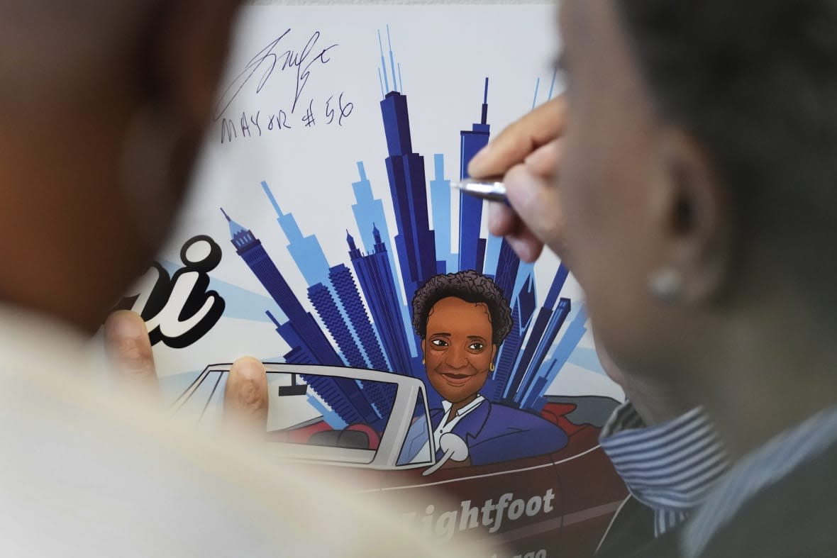 Chicago mayor Lori Lightfoot autographs a poster for a supporter after Women for Lori Rally in Chicago, Saturday, Feb. 25, 2023. Lightfoot is fighting for reelection Tuesday after a history-making but tumultuous four years in office and a bruising campaign threaten to make her the city’s first one-term mayor in decades. (AP Photo/Nam Y. Huh)