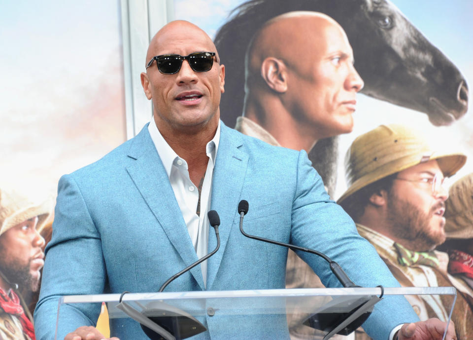 Dwayne Johnson speaks at a podium