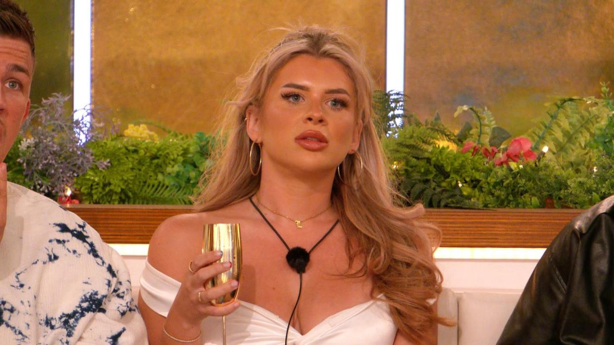 liberty poole holding a champagne flute looking stunned on love island all stars, day 3