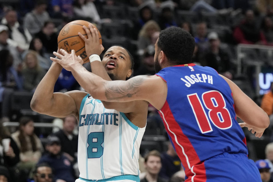 Charlotte Hornets guard Dennis Smith Jr. (8) is defended by Detroit Pistons guard Cory Joseph (18) during the first half of an NBA basketball game, Thursday, March 9, 2023, in Detroit. (AP Photo/Carlos Osorio)