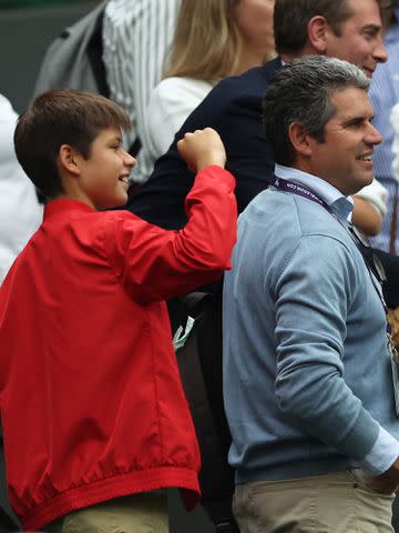 <p>Clive Brunskill/Getty </p> Carlos Alcaraz's Brother Jaime Alcaraz, and Father Carlos Alcaraz Gonzalez listen to Carlos Alcaraz's winning interview at The Championships Wimbledon 2023