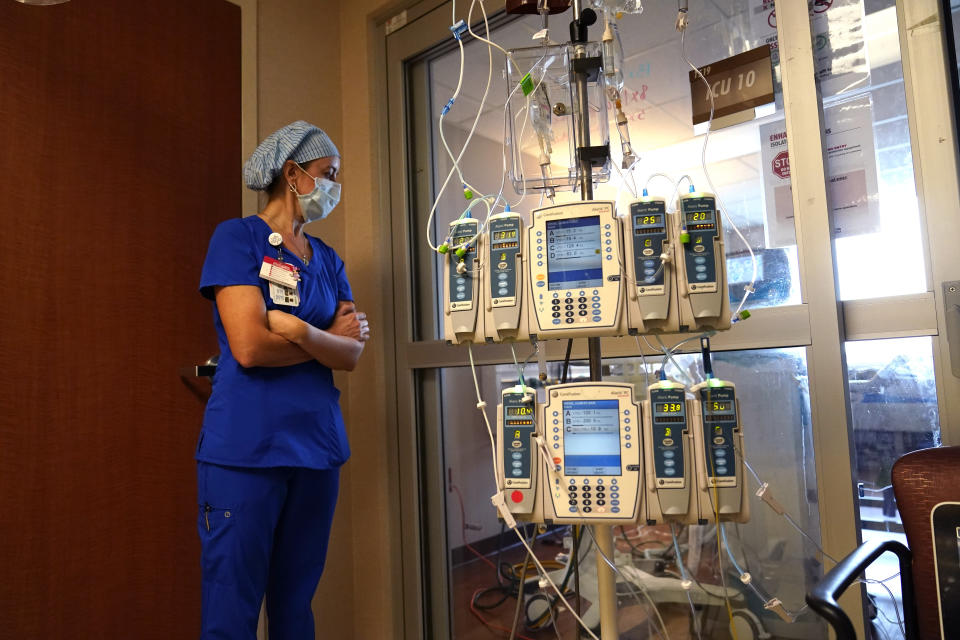 Nursing coordinator Beth Springer looks into a patient's room in a COVID-19 ward at the Willis-Knighton Medical Center in Shreveport, La., Tuesday, Aug. 17, 2021. “I see a lot of sadness. I see a lot that I never thought I’d see in my career,” said Springer, who has been a nurse nearly 20 years. (AP Photo/Gerald Herbert)