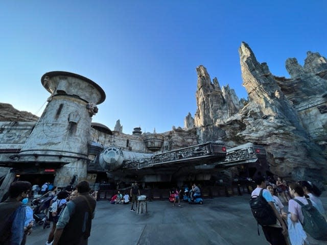 Guests gather around the Millennium Falcon in the heart of Disneyland's Star Wars: Galaxy's Edge.