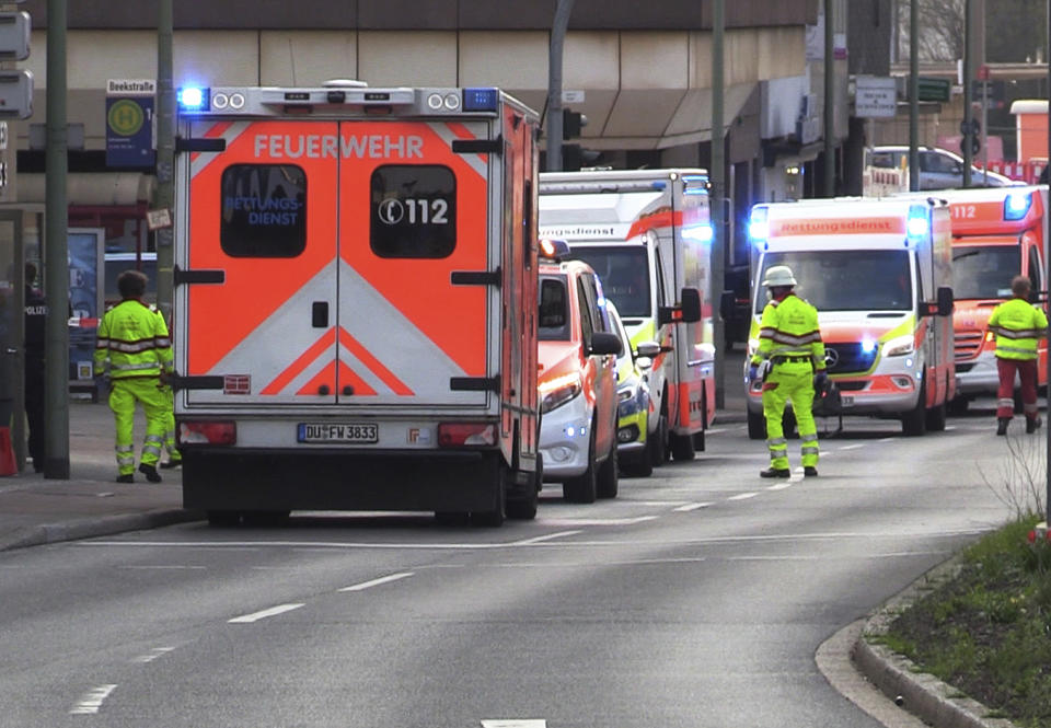 Ambulances and helpers are on duty in front of a health club in Duisburg, Germany, Tuesday, April 18, 2023. German police say at least four people have been severely injured in an attack at a gym in the western city of Duisburg. Tuesday evening’s attack occurred in the old city of Duisburg and police asked residents to avoid the area. (Justin Brosch/dpa via AP)