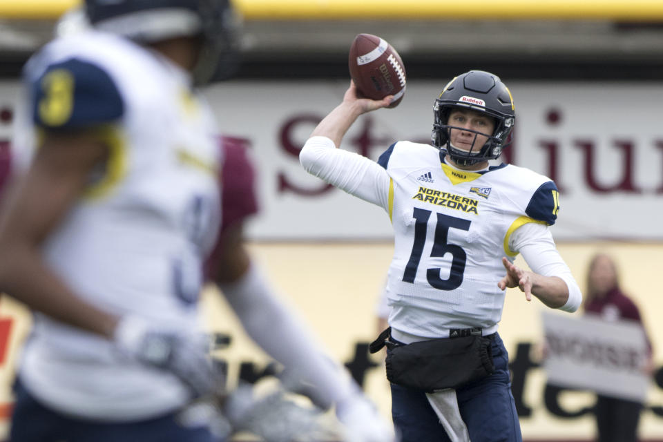 Northern Arizona quarterback Case Cookus (15) throws a pass against Montana in the first quarter of an NCAA college football game Saturday, Nov. 4, 2017, in Missoula, Mont. (AP Photo/Patrick Record)