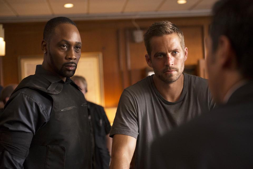 This image released by Relativity Media shows RZA, left, and Paul Walker in a scene from "Brick Mansions." (AP Photo/Relativity Media, Philippe Bosse)