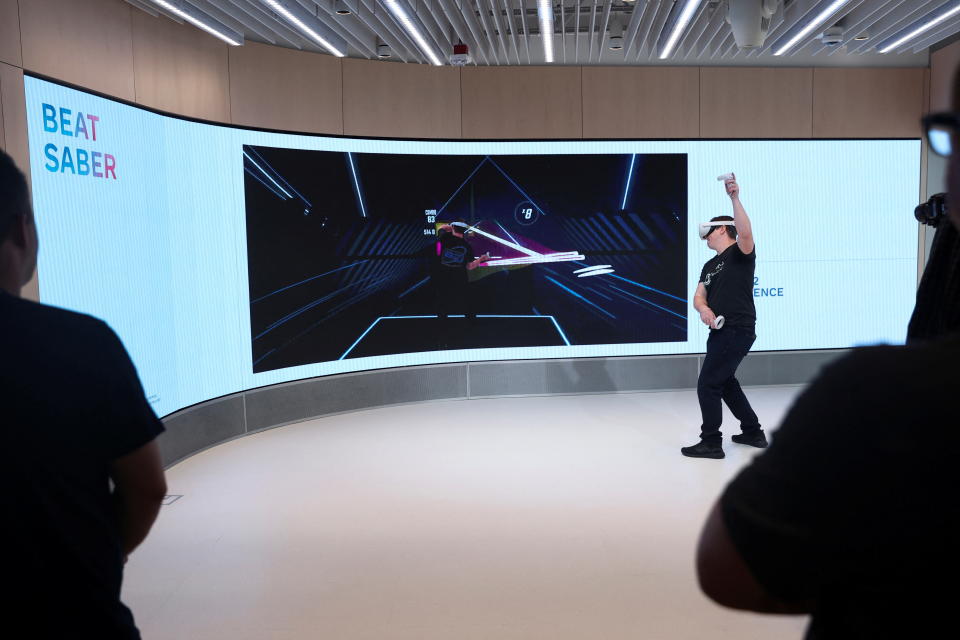 A person plays Beat Saber in the Quest Experience during a preview of the inaugural physical store of Facebook-owner Meta Platforms Inc in Burlingame, California, U.S. May 4, 2022. REUTERS/Brittany Hosea-Small