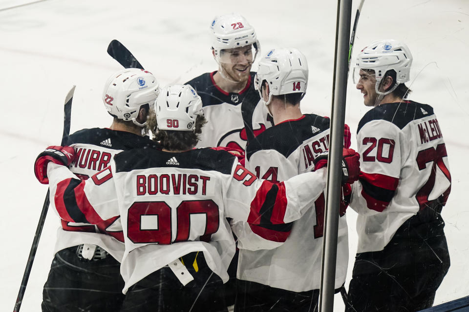 New Jersey Devils' Michael McLeod (20) celebrates with teammates after scoring a goal during the second period of the team's NHL hockey game against the New York Islanders on Thursday, May 6, 2021, in Uniondale, N.Y. (AP Photo/Frank Franklin II)