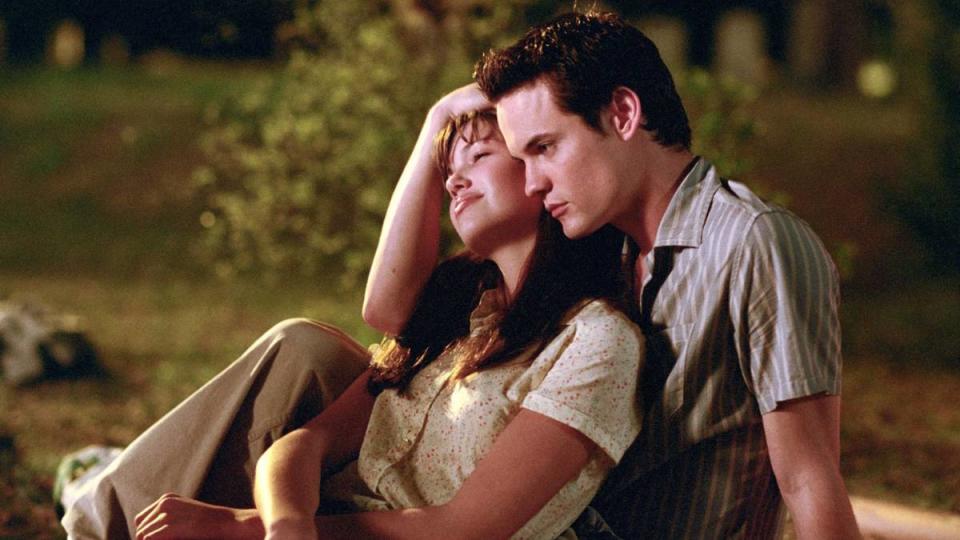 Woman leaning back into a man’s chest ; Nicholas Sparks movies