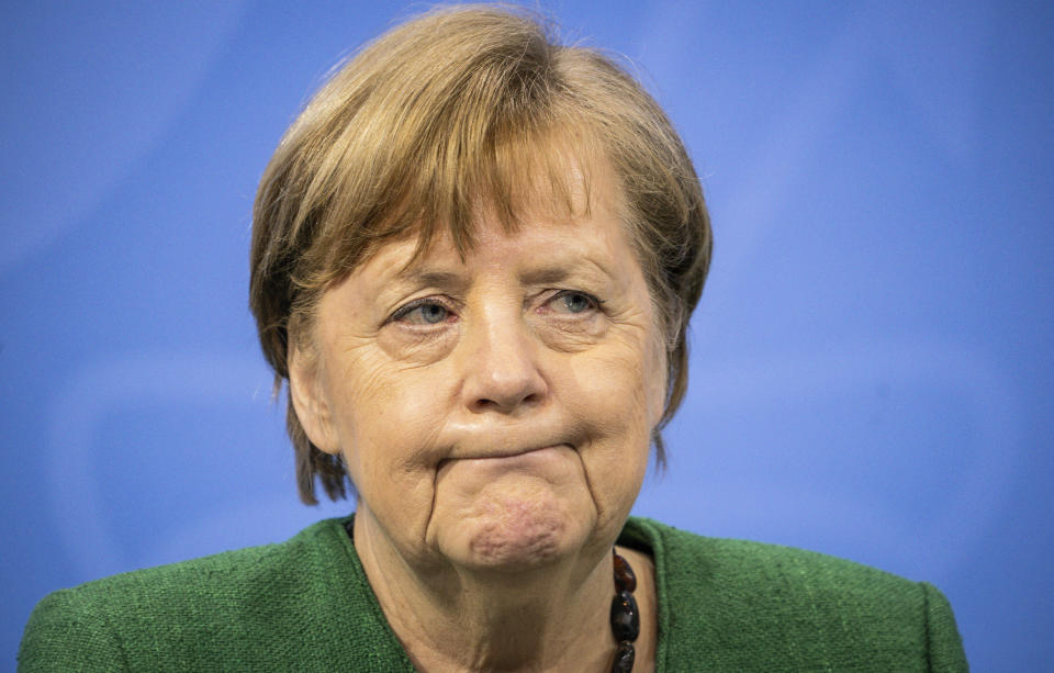 German Chancellor Angela Merkel attends a press conference in the Chancellor's Office following consultations between the federal and state governments in Berlin Tuesday, March 23, 2021. Germany extended its lockdown measures by another month and imposed several new restrictions, including largely shutting down public life over Easter, in an effort to drive down the rate of coronavirus infections. (Michael Kappeler/Pool Photo via AP)