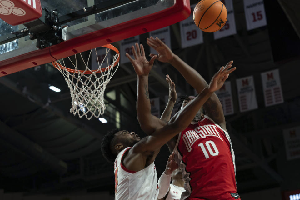 Maryland's Donta Scott, left, blocks the shot of Ohio State's player Brice Sensabaugh (10) during the first half of an NCAA college basketball game, Sunday, Jan. 8, 2023, in College Park, Md. (AP Photo/Jose Luis Magana)