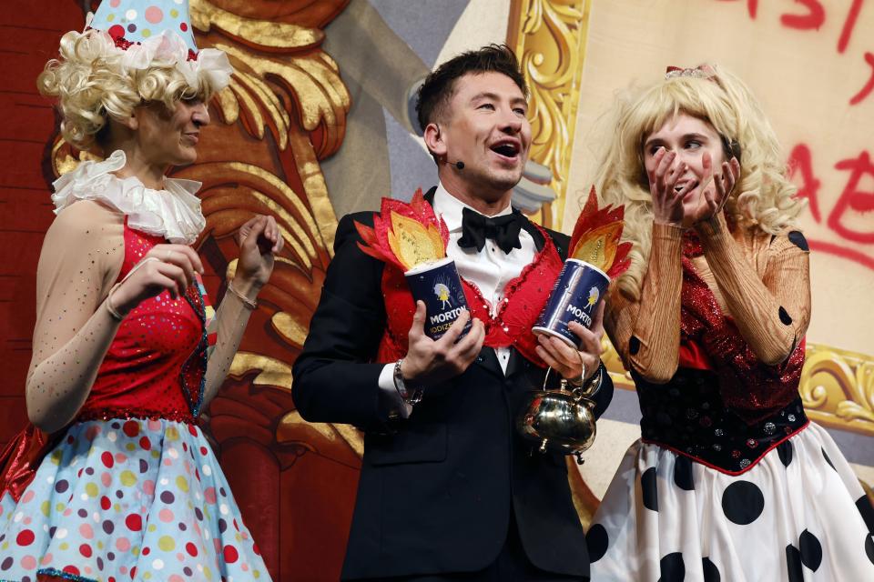 Harvard University's Hasty Pudding Theatricals Man of the Year Barry Keoghans, center, holds the Pudding Pot during a roast, Friday, Feb. 2, 2024, in Cambridge, Mass. (AP Photo/Michael Dwyer)