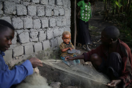 Men repair fishing nets, at Kagorwa Pygmy camp on Idjwi island in the Democratic Republic of Congo, November 25, 2016. REUTERS/Therese Di Campo