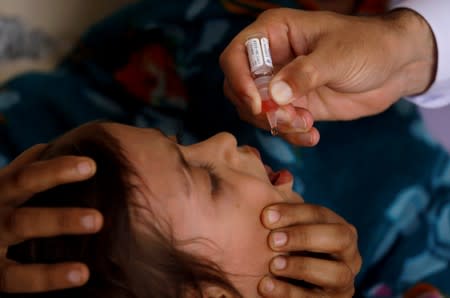 FILE PHOTO: Polio vaccine drops are administered to a child at a civil dispensary in Peshawar