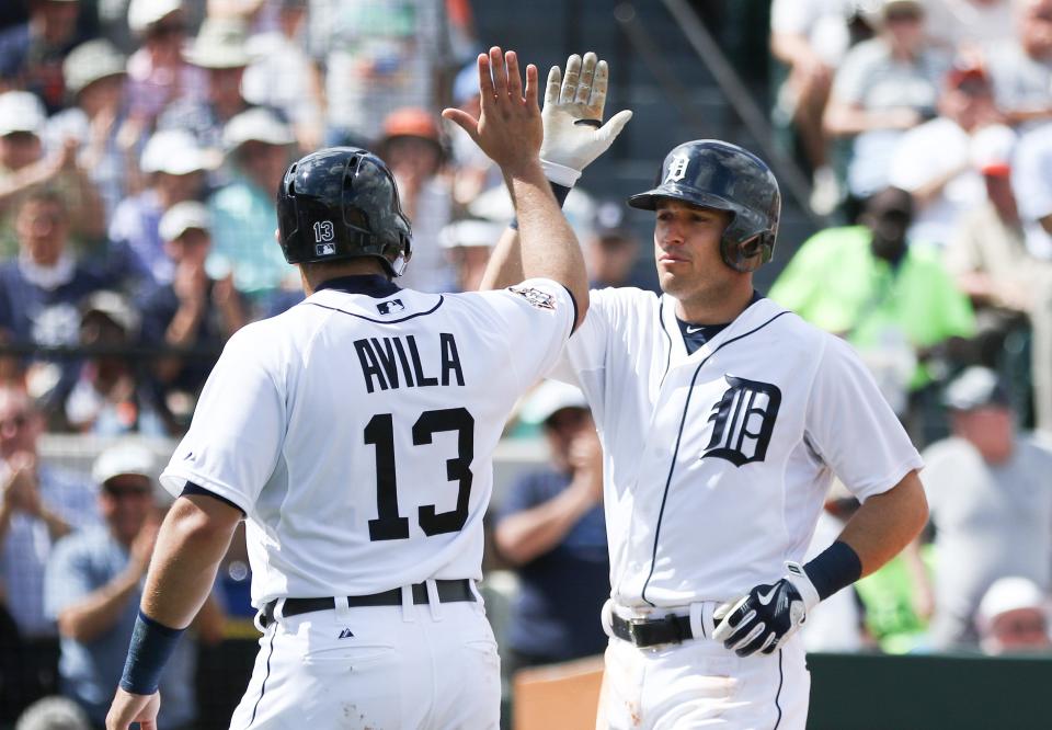 Detroit Tigers second baseman Ian Kinsler, right, high-fives catcher Alex Avila on March 3, 2015.