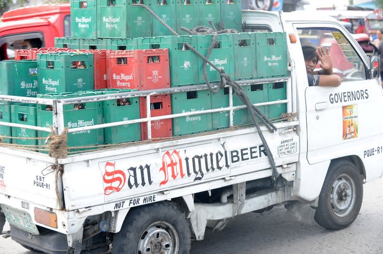 A man delivers San Miguel beer products in Manila on April 4, 2012