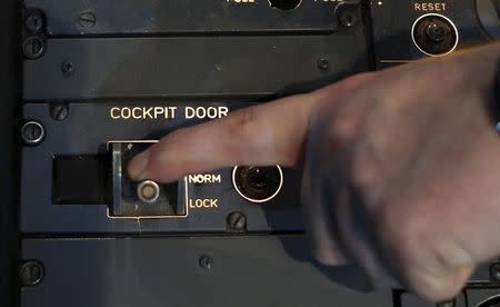 Gerhard Lueck, CEO of ViennaFlight, shows the door locking system of an Airbus A320 inside a flight simulator in Vienna on March 26, 2015. REUTERS/Leonhard Foeger