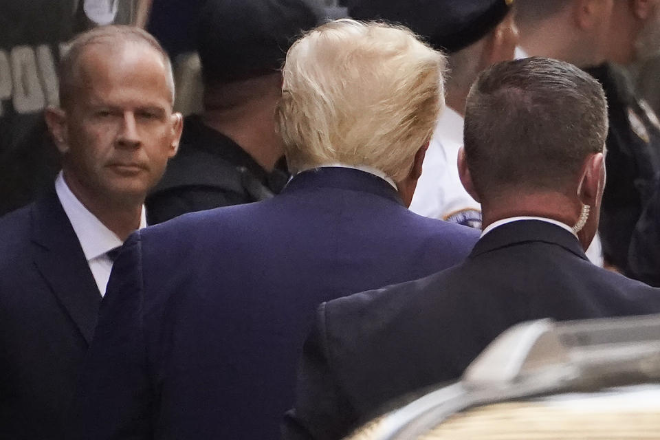 Former President Donald Trump, center, arrives at the Manhattan District Attorney's office, Tuesday, April 4, 2023, in New York. Trump is set to appear in a New York City courtroom on charges related to falsifying business records in a hush money investigation, the first president ever to be charged with a crime. (AP Photo/John Minchillo)