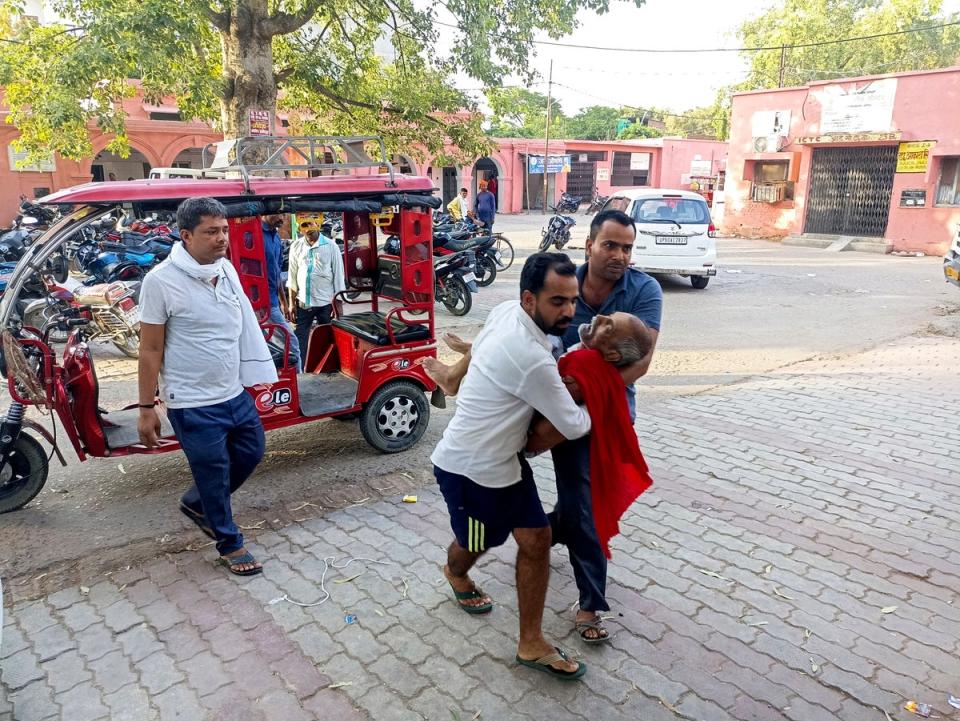An elderly man is carried to a hospital in Ballia district (AP)