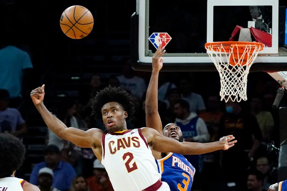 Cleveland Cavaliers guard Collin Sexton (2) and Phoenix Suns guard Chris Paul (3) vie for a jump ball during the second half of an NBA basketball game Saturday, Oct. 30, 2021, in Phoenix. The Suns won 101-92. (AP Photo/Ross D. Franklin)