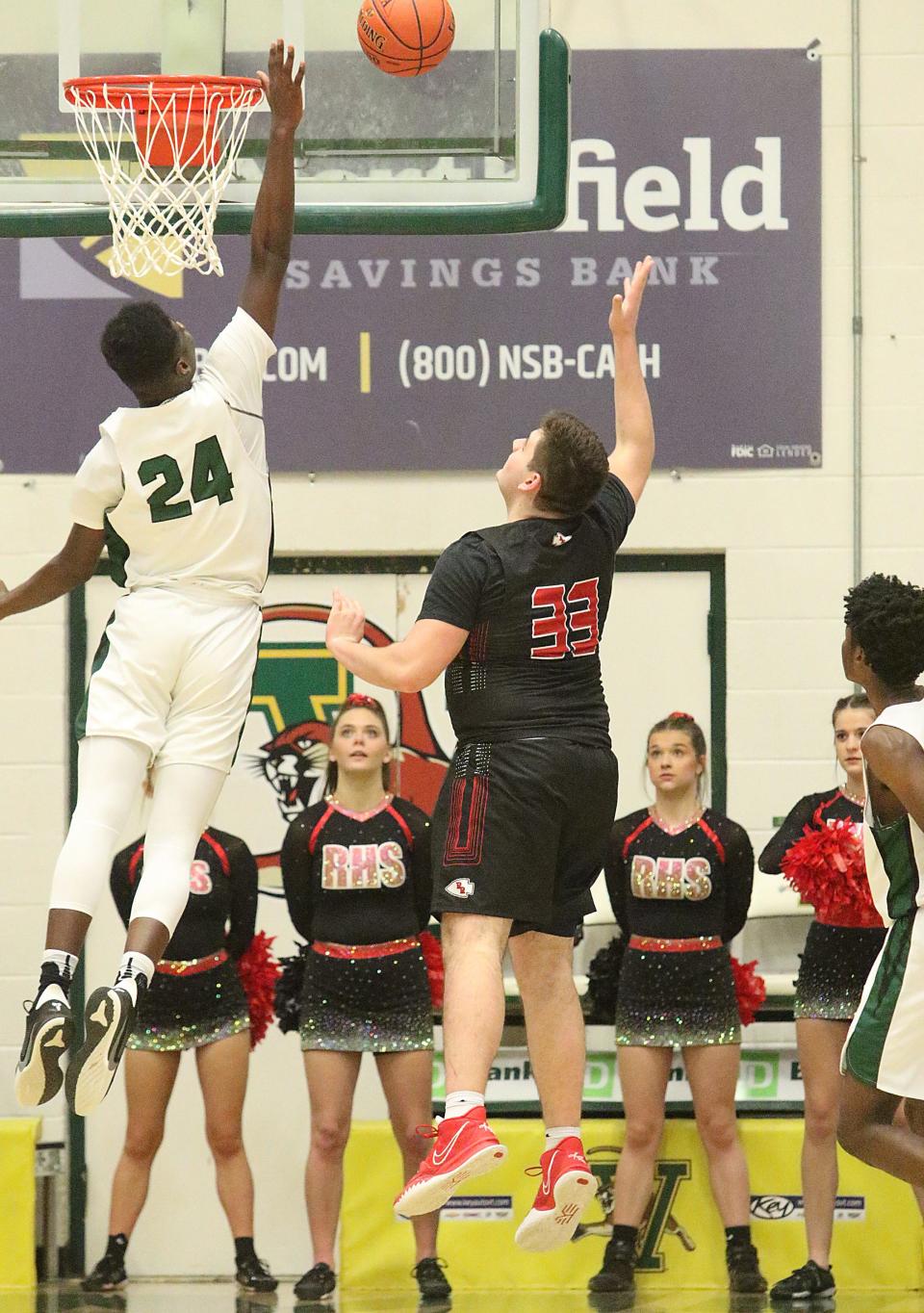 Rice's Mo Kanneh blocks Rutland's Luke DelBianco's shot during the Green Knights 45-41 win over the Raiders in the D1 Championship at UVM's Patrick Gym.
