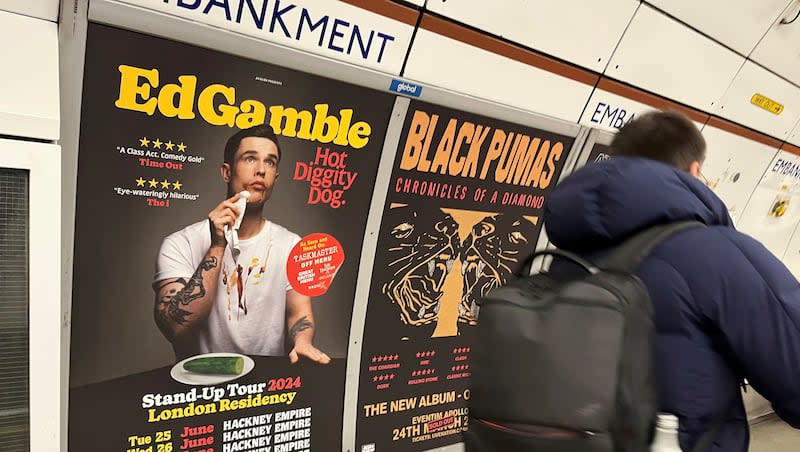 A  view of a poster advertising comedian Ed Gamble's "Hot Diggity Dog" tour on the Bakerloo line platform at Embankment underground station in London, Wednesday March 27, 2024. Gamble has been ordered to change a subway station poster campaign for his new standup show because the image of a hot dog violated the transit network’s ban on junk food advertising. The poster for the show, “Hot Diggity Dog,” showed a mustard- and ketchup-smeared Gamble beside a half-eaten hot dog on a plate. A bemused Gamble replaced the wiener with a cucumber, and the poster was approved.