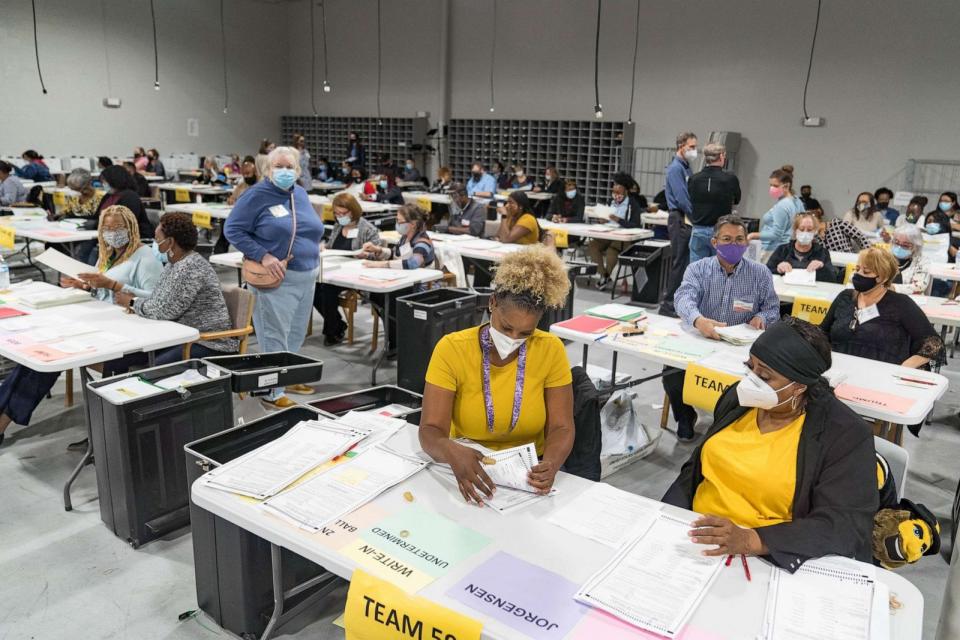 PHOTO: Gwinnett County election workers handle ballots as part of the recount for the 2020 presidential election at the Beauty P. Baldwin Voter Registrations and Elections Building, Nov. 16, 2020 in Lawrenceville, Ga. (Megan Varner/Getty Images)