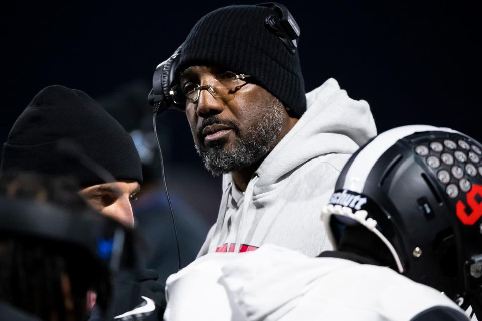 Aliquippa head coach Mike Warfield joins the huddle during a timeout in the PIAA Class 4A football championship game against Dallas at Cumberland Valley High School, Thursday, Dec. 7, 2023, in Mechanicsburg, Pa.