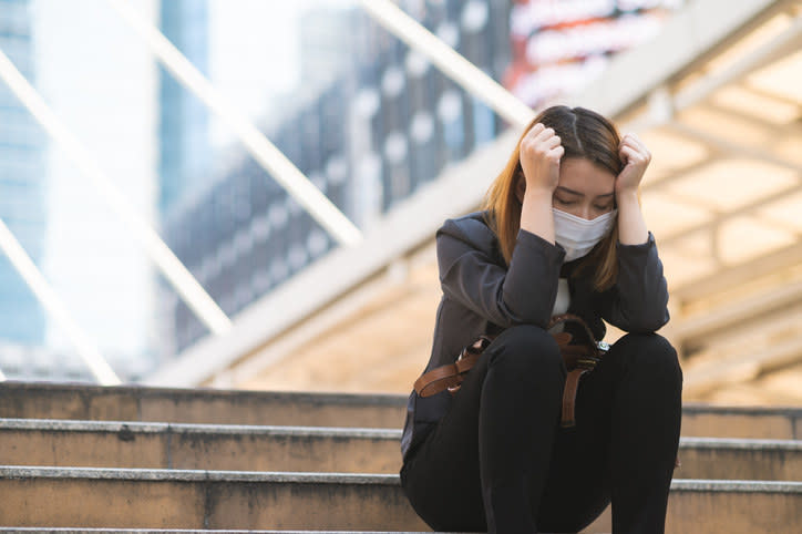 Unemployed businesswoman depressed sitting on a staircase