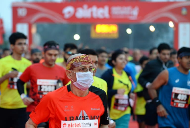 A man wears a face mask as he competes in the Delhi half-marathon