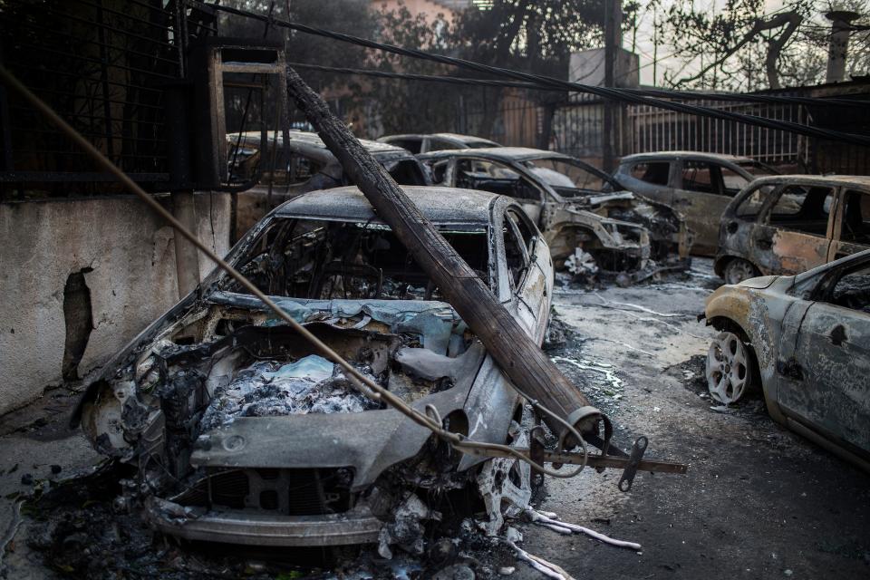 Burnt out cars line the streets in the resort of Matti, near Athens (Getty Images)