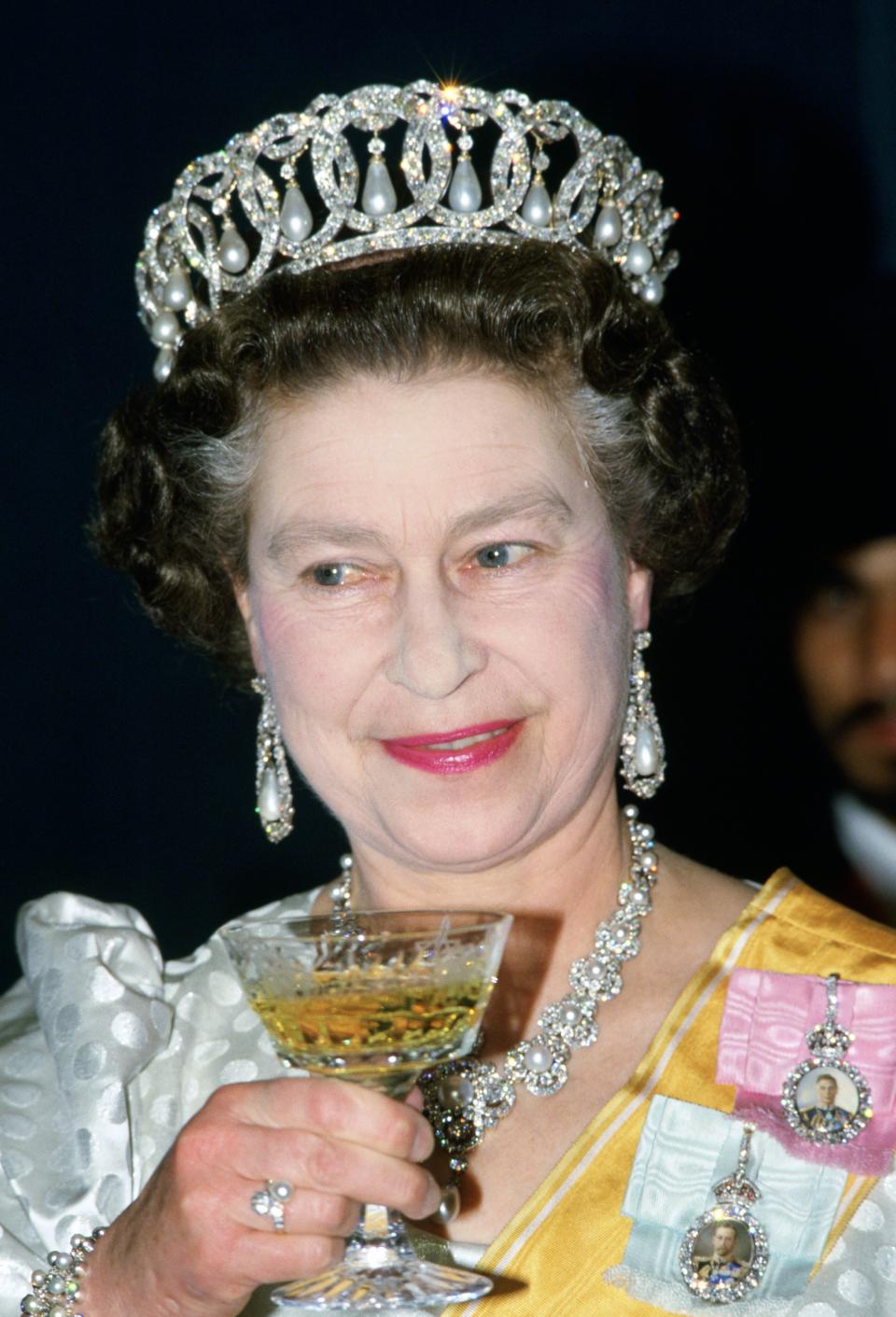 NEPAL - FEBRUARY 19:  Queen Elizabeth II drinks champagne at a State Banquet in Nepal  (Photo by Tim Graham Photo Library via Getty Images)