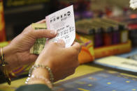 <p>Customer buys a Powerball ticket, Aug. 22, 2017, in Chicago, officials estimated jackpot for Wednesday night’s Powerball lottery game has climbed to $700 million, making it the second largest in U.S. history. (Photo: G-Jun Yam/AP) </p>