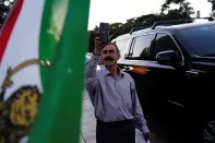 <p>Ardalan Goran, an Iranian Kurd, uses his iPhone while recording fellow demonstrators at a protest following the death of Mahsa (Zhina) Amini, a young Iranian Kurdish woman, outside the Wilshire Federal Building in Los Angeles, California, U.S., September 22, 2022. REUTERS/Bing Guan</p> 