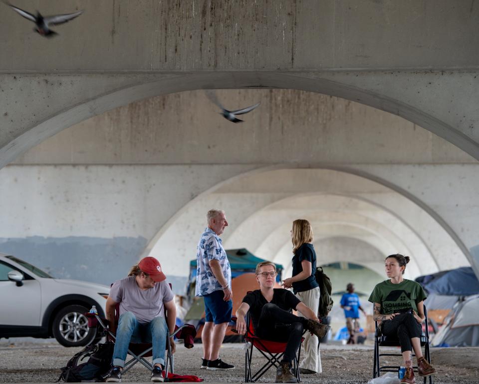 Open Table Nashville outreach workers Chase Cate, Emery Nash, and India Pungarcher keep watch at the camp under the Jefferson Street bridge on Tuesday, June 1, 2021, in Nashville, Tenn. Organizations, including Open Table Nashville, have been speaking out against the eviction of those living in the encampment under the Jefferson Street bridge after Metro Nashville Police Department announced a plan to close it.