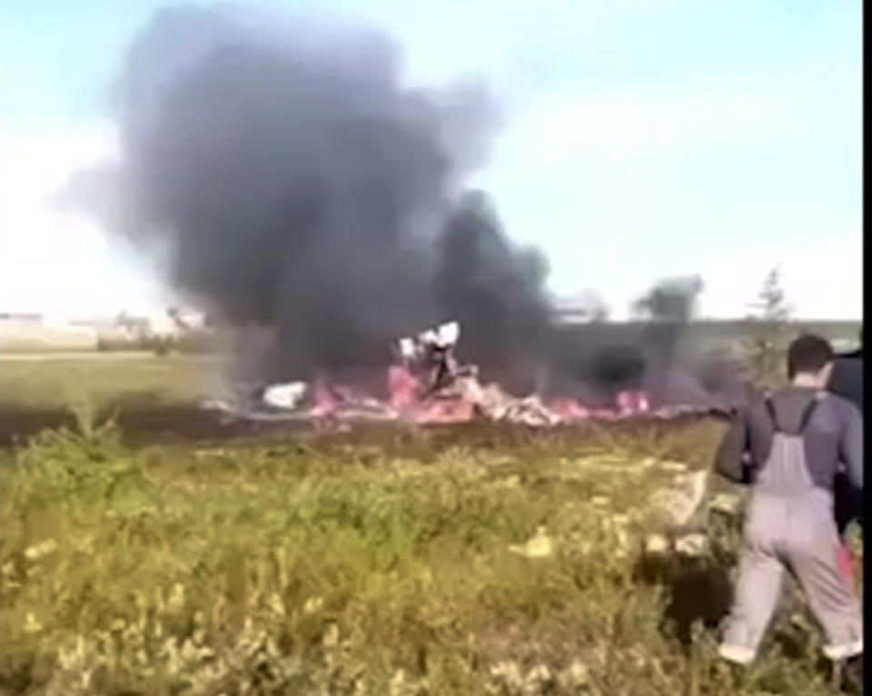 In this image made video, smoke rises from a crash side of a Russian helicopter Mi-8 crashed shortly after takeoff in Vankor, above the Arctic Circle in Siberia, Russia, Saturday, Aug. 4, 2018. A Russian helicopter crashed shortly after takeoff in Siberia on Saturday, killing all 18 people aboard. The Interstate Aviation Committee, which oversees civil aviation in much of the former Soviet Union, said the Mi-8 helicopter collided with the load being carried by another helicopter that had taken off from the same pad in Vankor, above the Arctic Circle about 2,600 kilometers (1600 miles) northeast of Moscow. The second helicopter was undamaged and landed safely, the committee said. (@CHP.KRAS via AP)