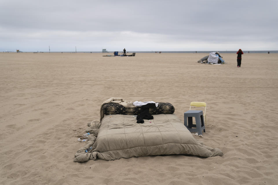 A homeless person's mattress and belongings sit on the beach in the Venice neighborhood of Los Angeles, Tuesday, June 29, 2021. The proliferation of homeless encampments on Venice Beach has sparked an outcry from residents and created a political spat among Los Angeles leaders. (AP Photo/Jae C. Hong)