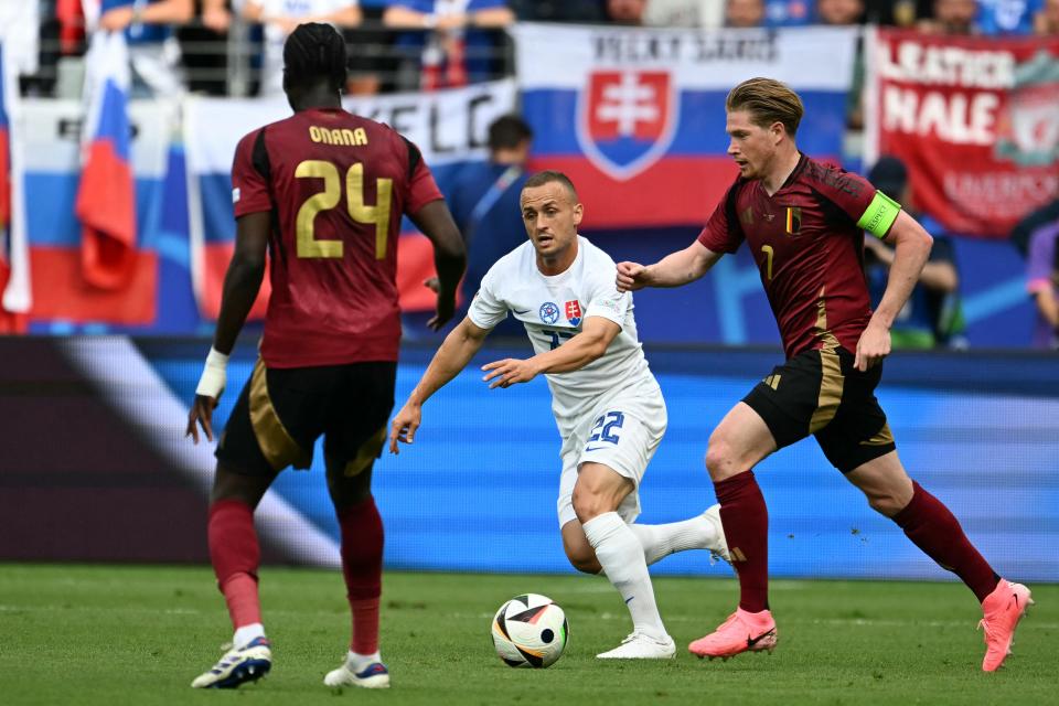 De Bruyne seeks control as Everton's Onana watches on (AFP via Getty Images)