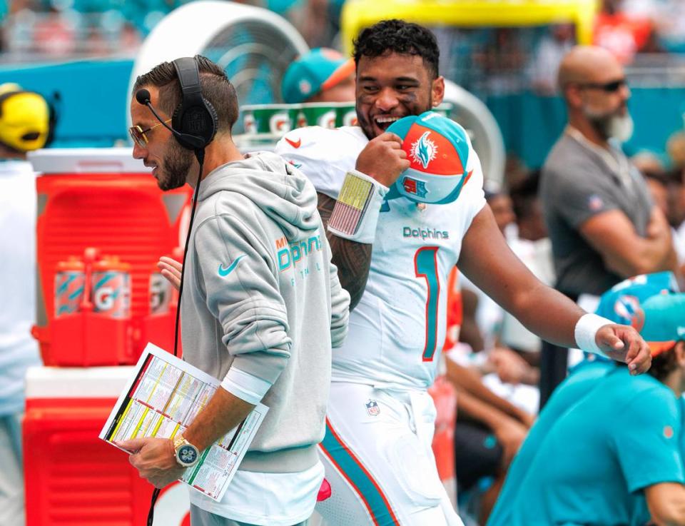Miami Dolphins head coach Mike McDaniel talks with Dolphins quarterback Tua Tagovailoa (1) during fourth quarter of an NFL football game against the Denver Broncos at Hard Rock Stadium on Sunday, Sept. 24, 2023 in Miami Gardens, Fl.