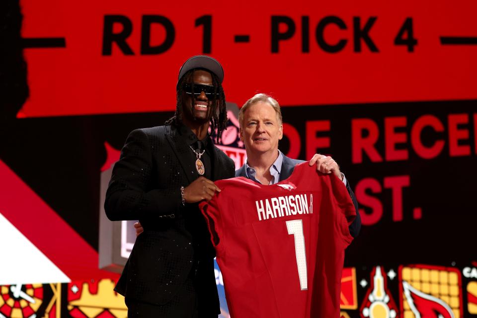 (L-R) Marvin Harrison Jr. poses with NFL Commissioner Roger Goodell after being selected fourth overall by the Arizona Cardinals during the first round of the 2024 NFL Draft at Campus Martius Park and Hart Plaza on April 25, 2024 in Detroit.